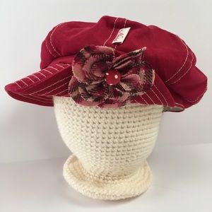 Pink brimmed hat with flower; newsboy hat